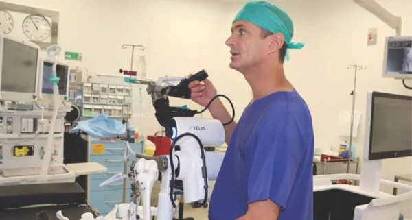 Surgeon with the VELYS robotic-assisted knee replacement system in theatre