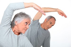 Older couple doing stretching exercises